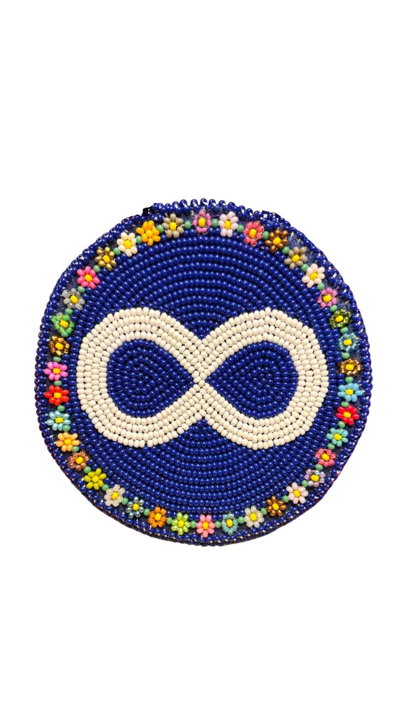 Hand-beaded Métis medallion — a white infinity symbol on royal blue, ringed with traditional floral beadwork